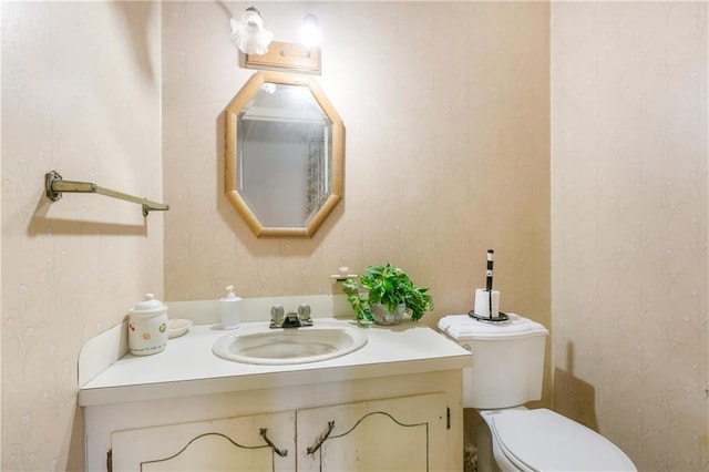 1805 13th Ave, Franklinton, LA 70438 - half bathroom featuring wallpapered walls, vanity, and toilet