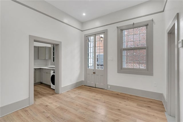 818 Bourbon St Unit 1C, New Orleans, LA 70116 - entrance foyer featuring light wood finished floors, washer / dryer, baseboards, and recessed lighting