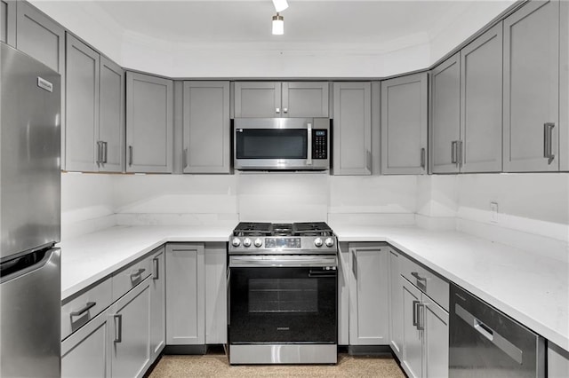 818 Bourbon St Unit 1C, New Orleans, LA 70116 - kitchen with appliances with stainless steel finishes, gray cabinets, and ornamental molding