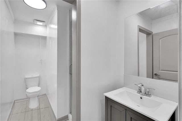 818 Bourbon St Unit 1C, New Orleans, LA 70116 - bathroom with vanity, toilet, tile patterned flooring, and ornamental molding
