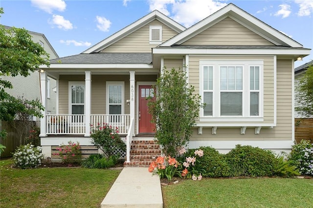 6038 Orleans Ave, New Orleans, LA 70124 - bungalow-style house featuring a shingled roof, covered porch, and a front lawn