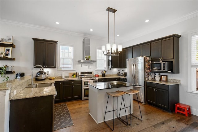 6038 Orleans Ave, New Orleans, LA 70124 - kitchen with wall chimney range hood, stainless steel appliances, a sink, and dark brown cabinets