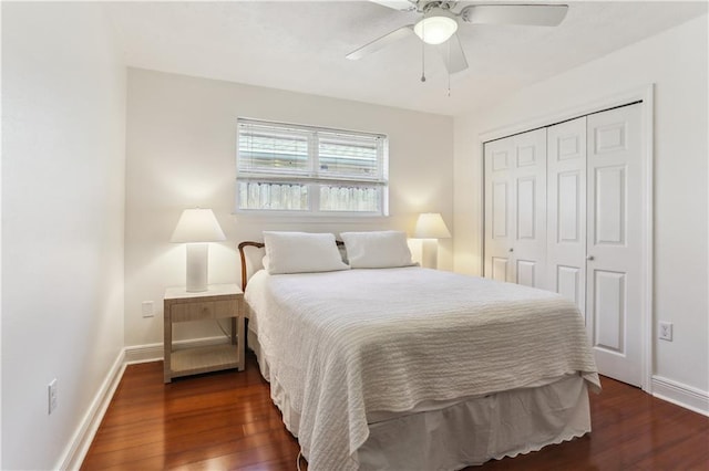 bedroom featuring dark wood-type flooring, a closet, baseboards, and a ceiling fan