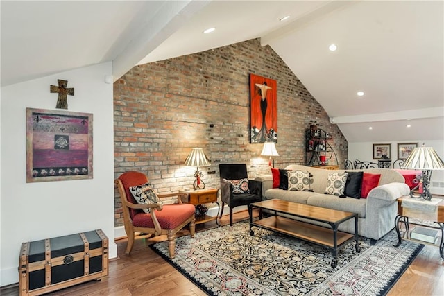 living room with brick wall, wood finished floors, and lofted ceiling with beams