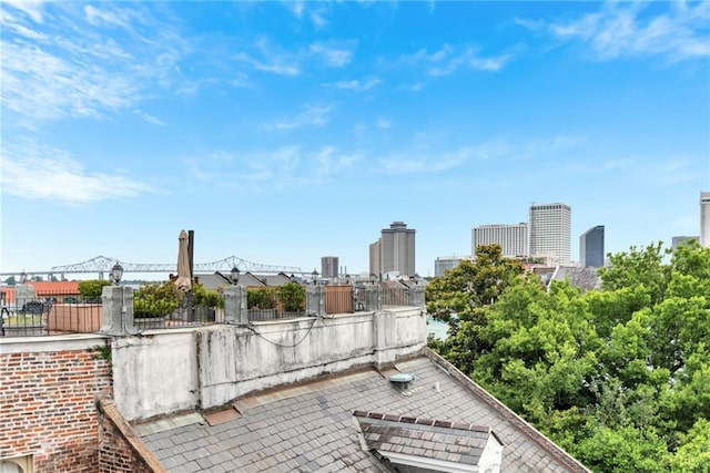 view of patio featuring fence and a view of city