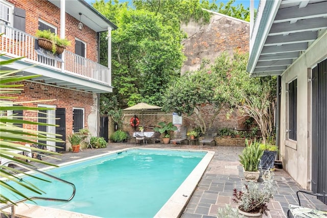 view of swimming pool featuring a fenced in pool and a patio
