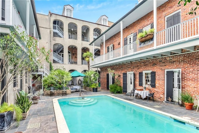 outdoor pool with a patio area