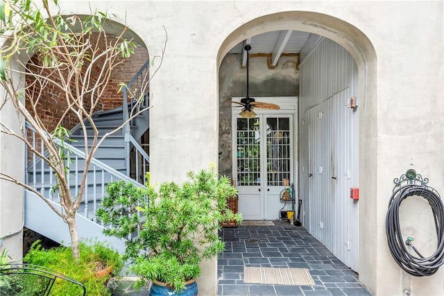 doorway to property featuring stucco siding