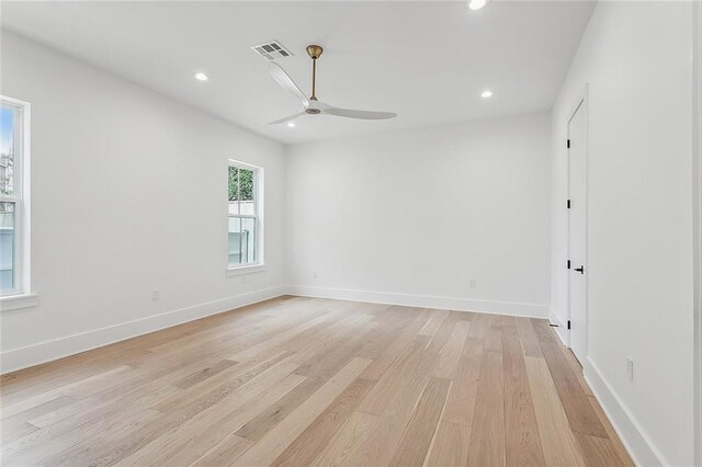 unfurnished room with light wood finished floors, a ceiling fan, baseboards, recessed lighting, and visible vents