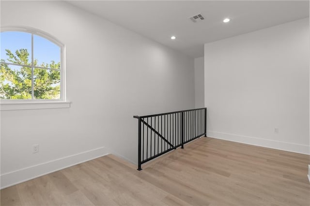unfurnished room with recessed lighting, baseboards, visible vents, and light wood-style flooring