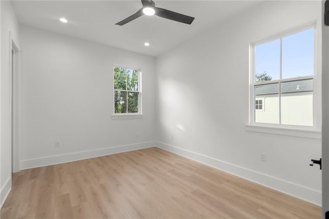 spare room featuring baseboards, a ceiling fan, light wood-style floors, and recessed lighting