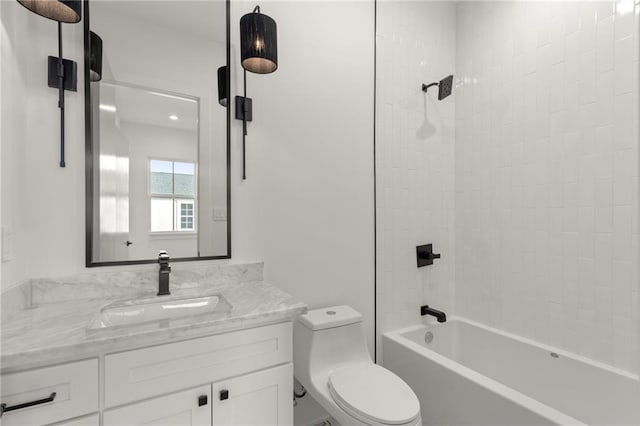 bathroom with vanity, bathing tub / shower combination, and toilet