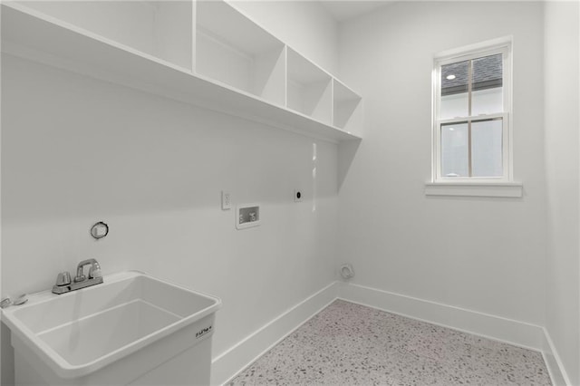 laundry room with baseboards, laundry area, a sink, and washer hookup