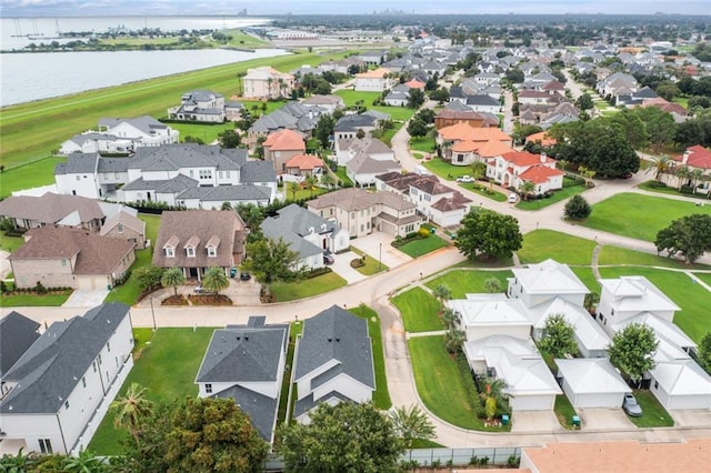 drone / aerial view with a water view and a residential view