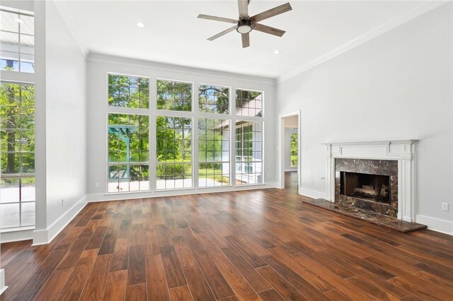 42 Green Hills Dr, Covington, LA 70435 - unfurnished living room with baseboards, crown molding, ceiling fan, a high end fireplace, and wood finished floors