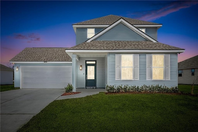 view of front of home featuring an attached garage, roof with shingles, a yard, and driveway
