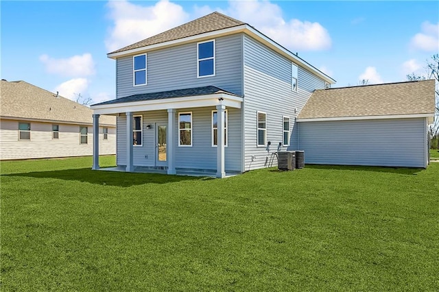 rear view of property featuring central AC, a lawn, and roof with shingles