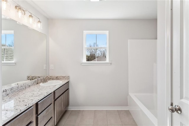 bathroom featuring a tub, vanity, tile patterned flooring, a shower, and baseboards