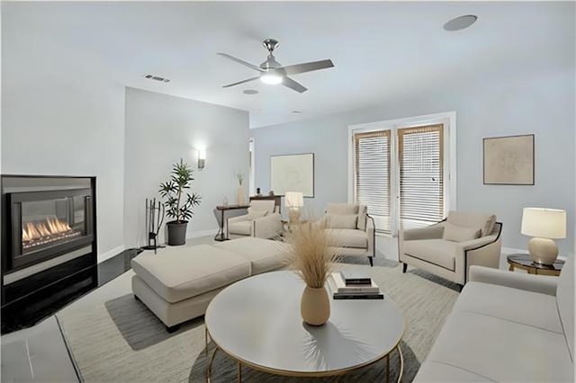 72315 Kustenmacher Rd, Abita Springs, LA 70420 - living room with a glass covered fireplace, a ceiling fan, and baseboards
