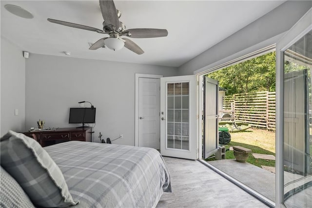 bedroom featuring a ceiling fan, access to exterior, and wood finished floors
