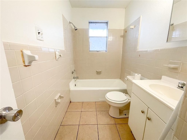 bathroom featuring toilet, tile walls, tile patterned flooring, and tub / shower combination