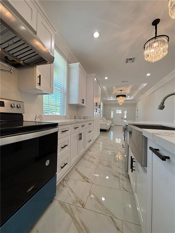 701 Frankilin Ave, Gretna, LA 70053 - kitchen with stainless steel electric range oven, visible vents, white cabinets, ornamental molding, and under cabinet range hood