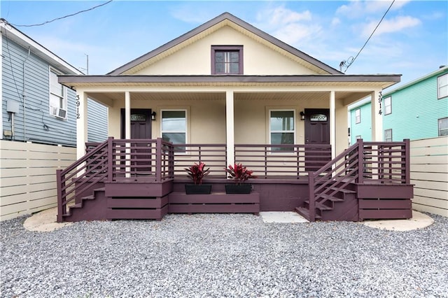 391214 Thalia St, New Orleans, LA 70125 - view of front of property featuring stucco siding, fence, and covered porch