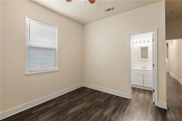 391214 Thalia St, New Orleans, LA 70125 - unfurnished bedroom featuring visible vents, baseboards, dark wood-style flooring, a sink, and connected bathroom