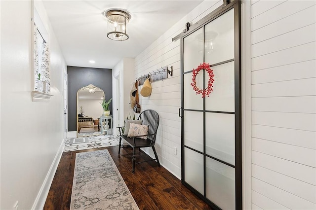 hallway featuring recessed lighting, baseboards, and dark wood-type flooring