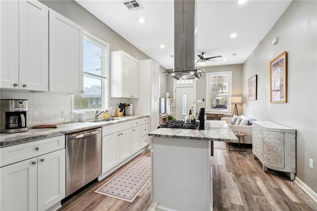 202729 Cambronne St, New Orleans, LA 70118 - kitchen with visible vents, a center island, a sink, wood finished floors, and stainless steel dishwasher