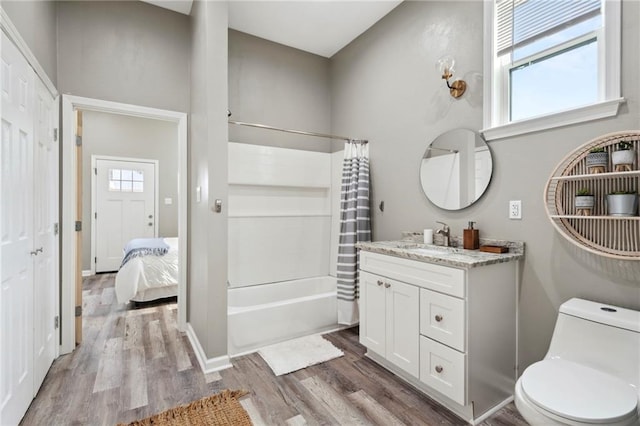 202729 Cambronne St, New Orleans, LA 70118 - bathroom featuring toilet, wood finished floors, vanity, and shower / tub combo with curtain