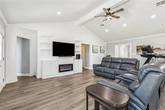 living area with a glass covered fireplace, visible vents, a ceiling fan, and light wood-style flooring