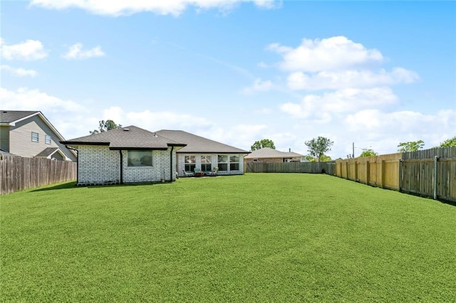 view of yard with a fenced backyard