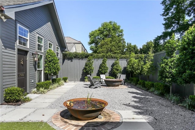 view of patio with a fenced backyard and a fire pit
