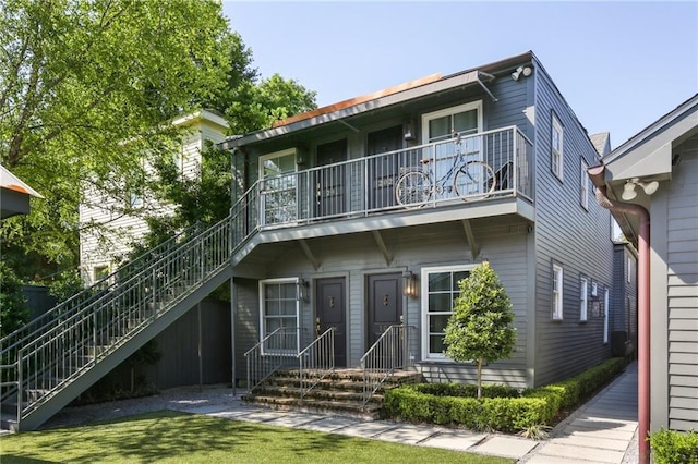 back of house featuring a balcony