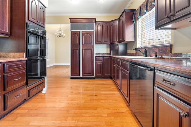 4516 Beau Lac Ln, Metairie, LA 70002 - kitchen with paneled refrigerator, stainless steel dishwasher, crown molding, a chandelier, and light wood-style floors