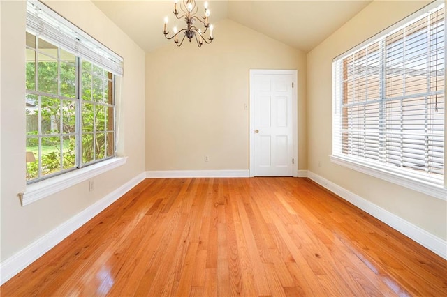 4516 Beau Lac Ln, Metairie, LA 70002 - unfurnished room with a chandelier, healthy amount of natural light, light wood finished floors, and vaulted ceiling