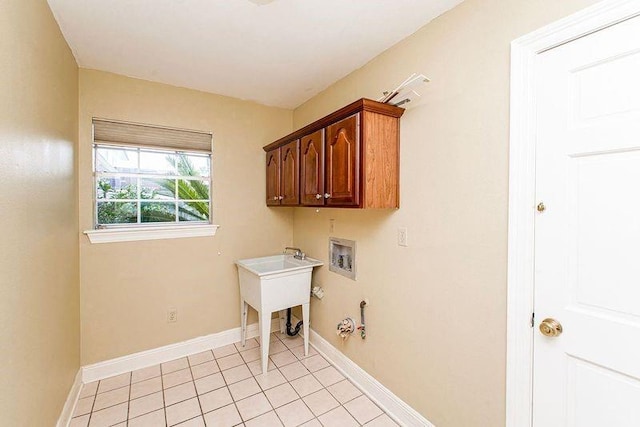 4516 Beau Lac Ln, Metairie, LA 70002 - washroom with baseboards, gas dryer hookup, light tile patterned floors, hookup for a washing machine, and cabinet space