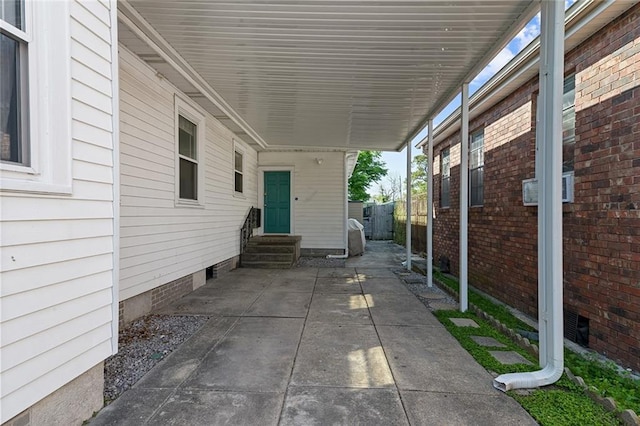 2524 Hamilton St, New Orleans, LA 70118 - view of patio featuring an attached carport, entry steps, and fence