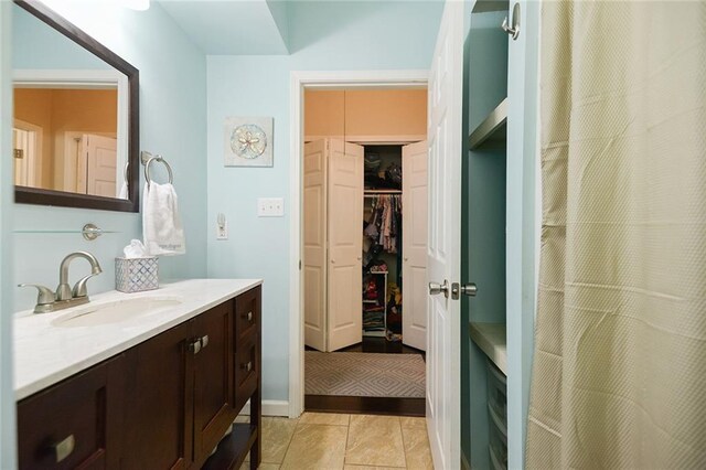2524 Hamilton St, New Orleans, LA 70118 - bathroom featuring tile patterned flooring, a spacious closet, and vanity