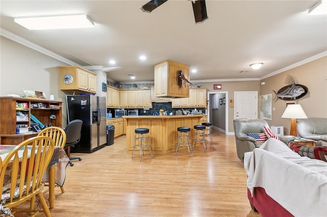kitchen with crown molding, tasteful backsplash, appliances with stainless steel finishes, open floor plan, and light wood finished floors