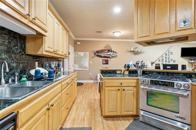 kitchen featuring visible vents, a sink, stainless steel gas range, crown molding, and decorative backsplash