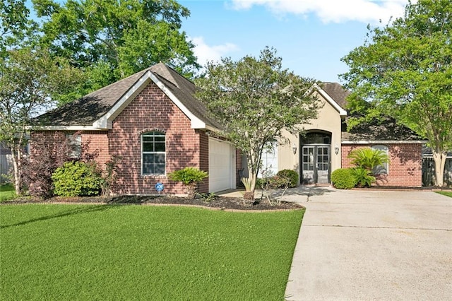 40339 Chandler Dr, Ponchatoula, LA 70454 - ranch-style home featuring brick siding, a front lawn, a garage, and concrete driveway