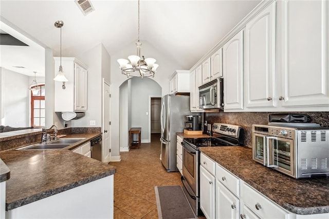 40339 Chandler Dr, Ponchatoula, LA 70454 - kitchen with dark countertops, visible vents, appliances with stainless steel finishes, and white cabinetry