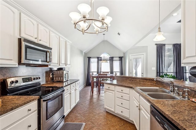 40339 Chandler Dr, Ponchatoula, LA 70454 - kitchen with appliances with stainless steel finishes, a chandelier, dark countertops, lofted ceiling, and a sink