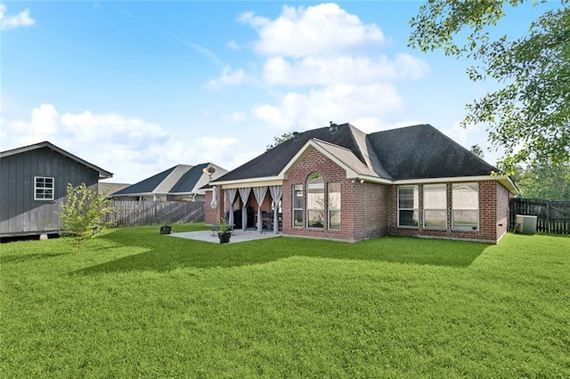 40339 Chandler Dr, Ponchatoula, LA 70454 - rear view of house featuring a patio, brick siding, a fenced backyard, central AC unit, and a lawn