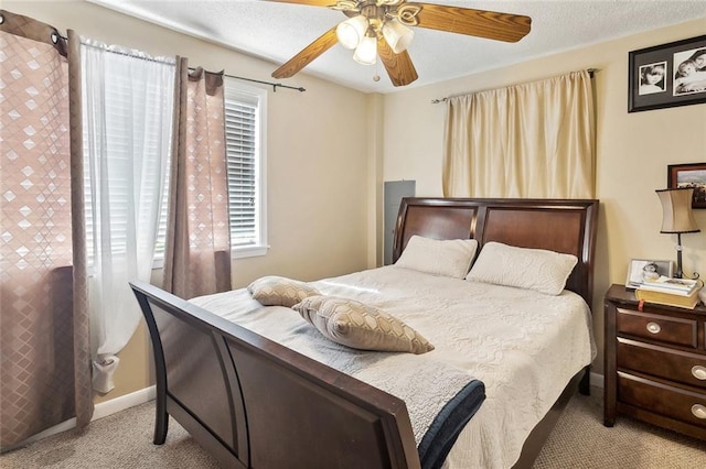bedroom featuring ceiling fan, baseboards, and carpet floors