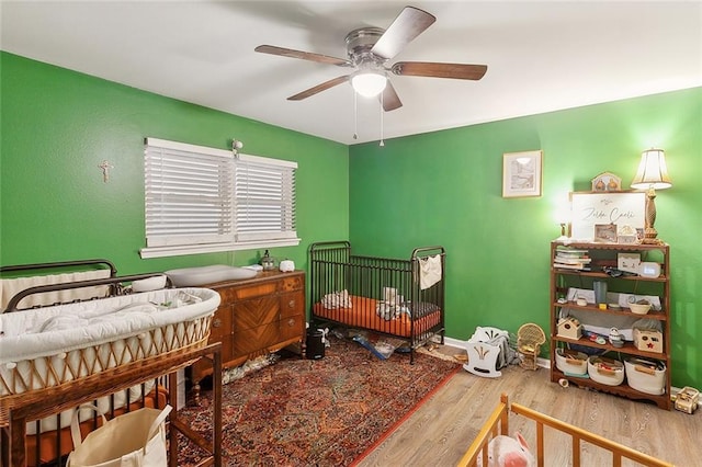 bedroom with a ceiling fan and wood finished floors