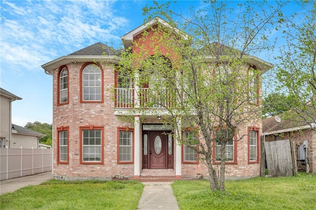 7721 Bullard Ave, New Orleans, LA 70128 - view of front of home with a balcony, fence, a front lawn, and brick siding