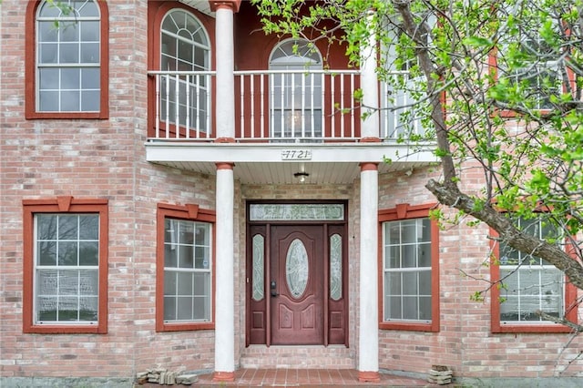 7721 Bullard Ave, New Orleans, LA 70128 - doorway to property with a balcony and brick siding